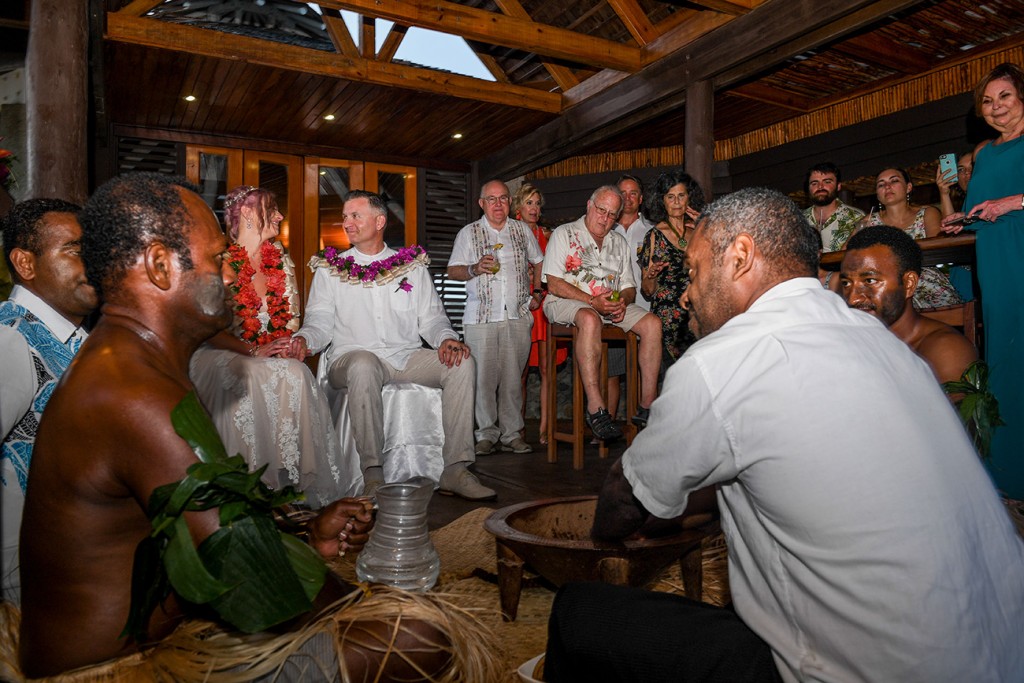 The wedding guests excitedly watch a traditional Fiji wedding ritual being performed