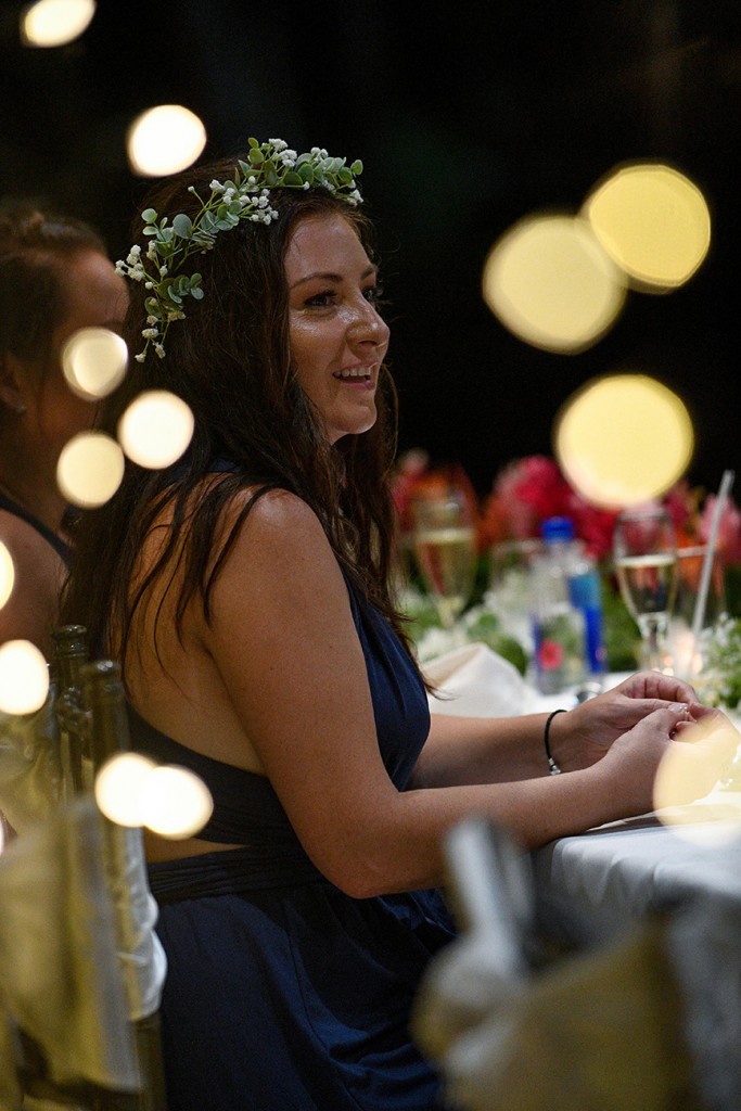A wedding guest watches the ceremony with joy
