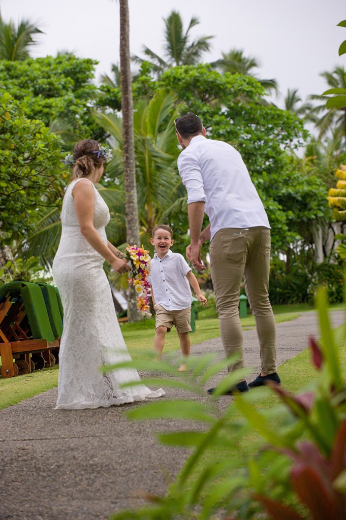 The bride and groom wait to hug their son at the Warwick Fiji