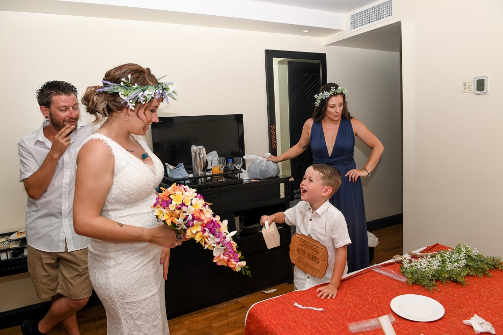 The bride has a good laugh with her son when finally ready to walk down the aisle