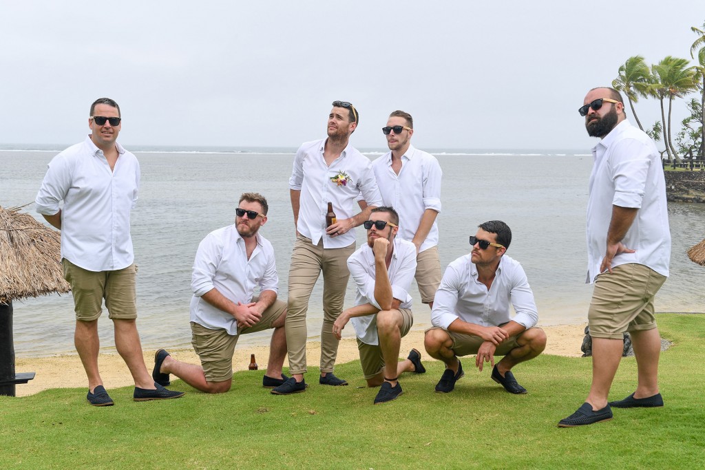 The groomsmen pose in front of the Pacific Ocean Fiji