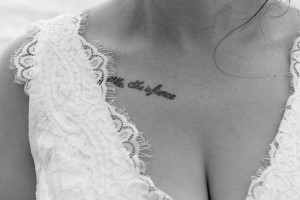 A closeup on the bride's "She is fierce" tattoo