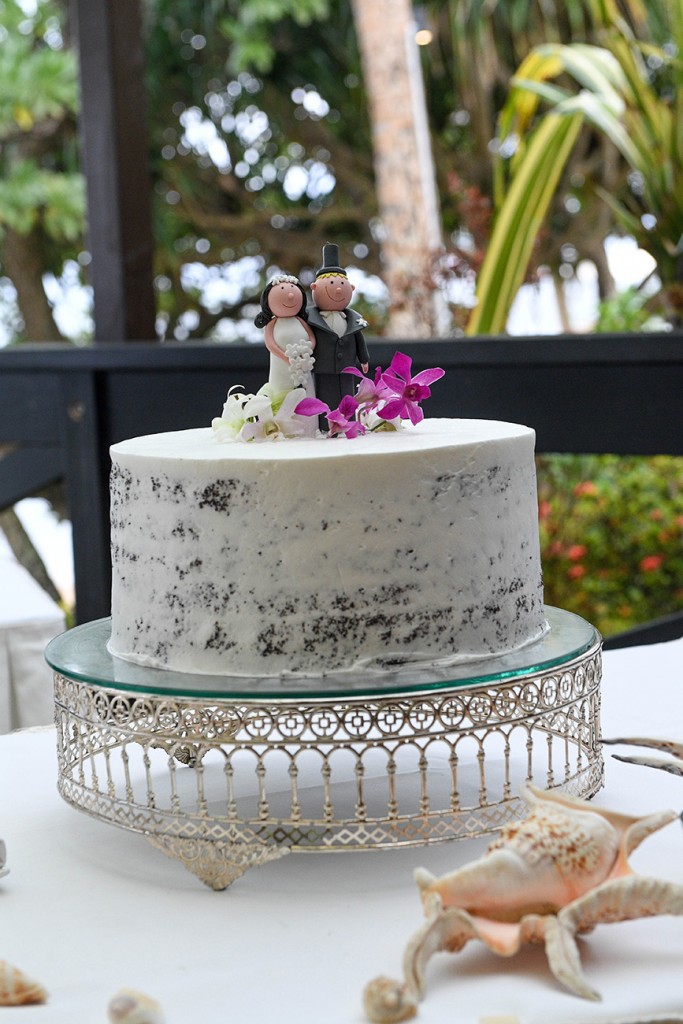 A simple, minimalistic, naked wedding cake with bob head toppers