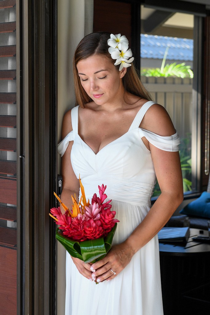 The bride holds a tropical ginger flower bouquet