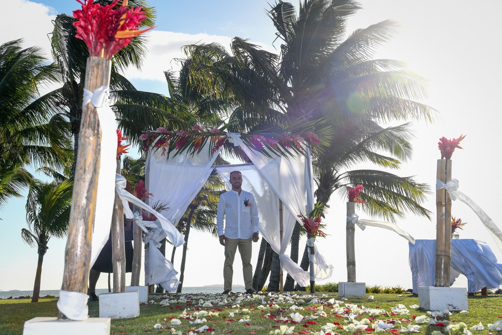 The dapper groom waits at the makeshift palm tree altar at the Fiji beach