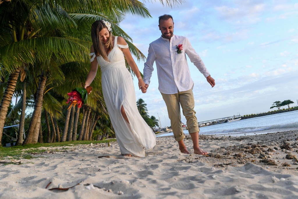 The married groom leaves footprints in the sand at the Vuda Marina beach Fiji