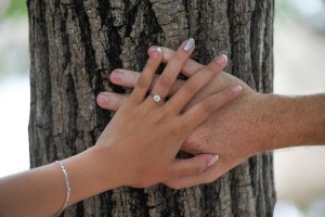 A closeup of the ring on the beautifully manicured nails of the bride