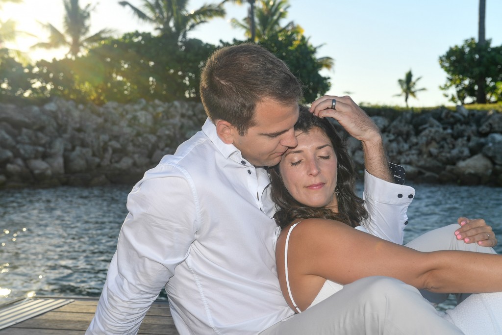 The bride and groom lovingly embrace in the Fijian sunset