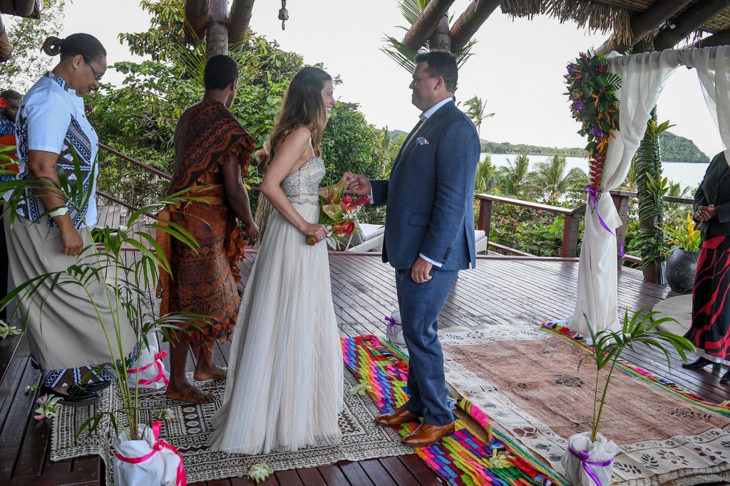 The groom receives the bride on the colourful Fiji altar
