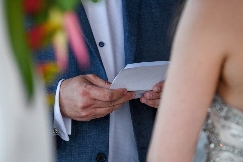 A closeup on the groom's vows