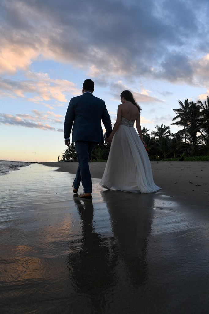 The newly weds stroll into the fading Fiji sunset