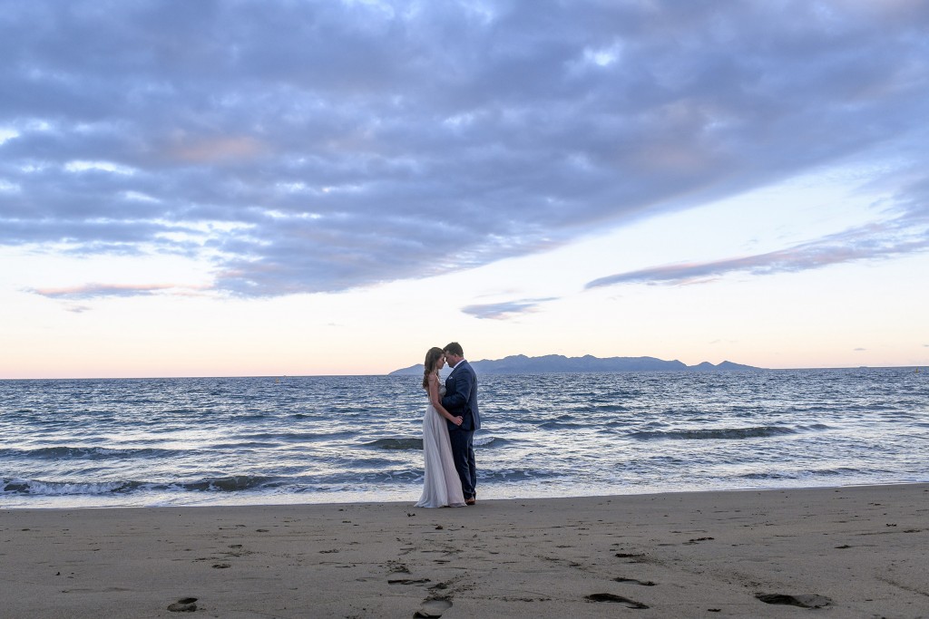 The couple share an intimate moment against the fading Fiji sunset
