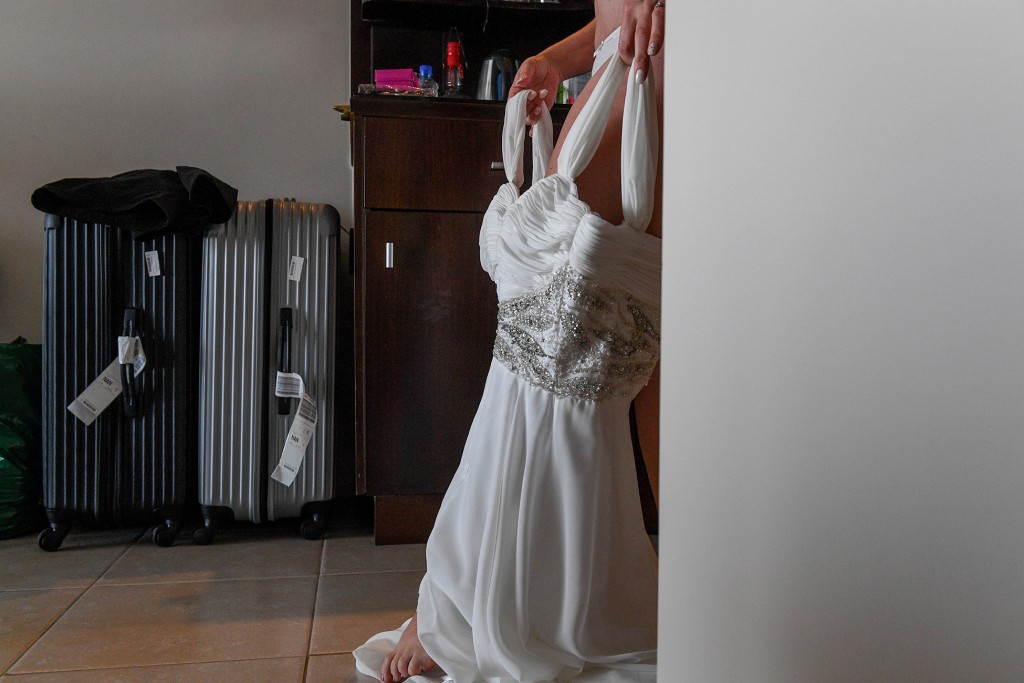 The bride steps into her stunning V neck wedding gown