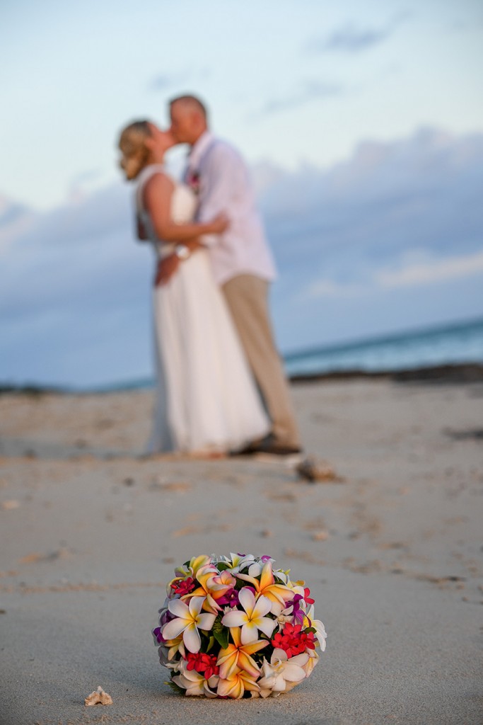 A blurred kiss with tropical Fiji flower bouquet in the foreground