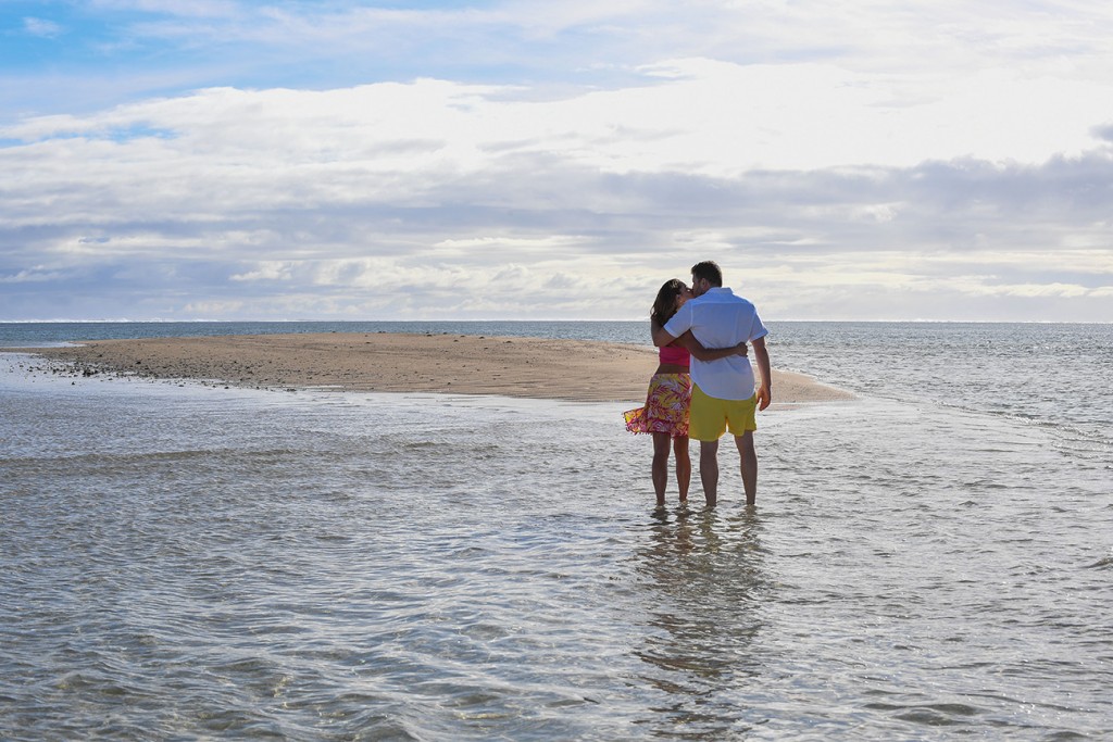 The couple embraces in the shallow waters of Nadi Fiji