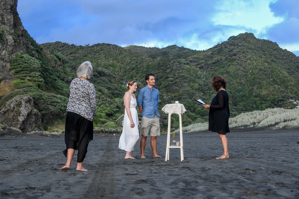 The marriage ceremony held on the black sand beach of Karekare
