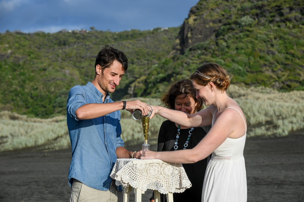 The couple perform a sand vow ceremony.