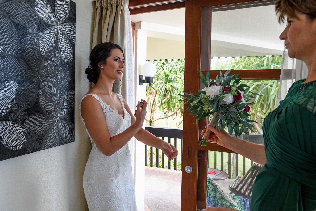 The bride splashes perfume onto herself before the ceremony