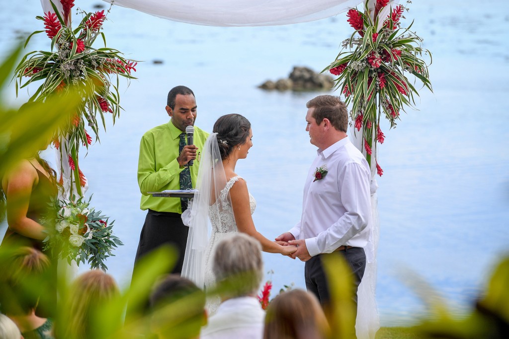 The groom receives the bride at the altar overlooking the Pacific ocean