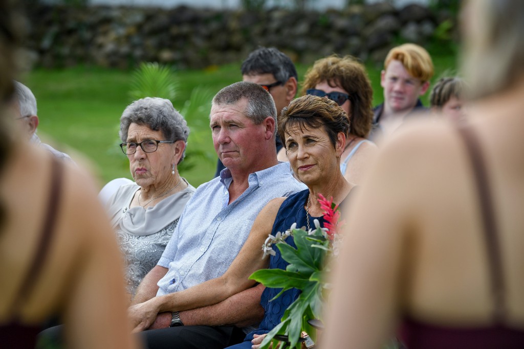 The parents of the groom watch the wedding vows passionately