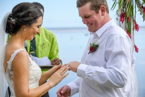 The bride slips the ring onto her groom's finger