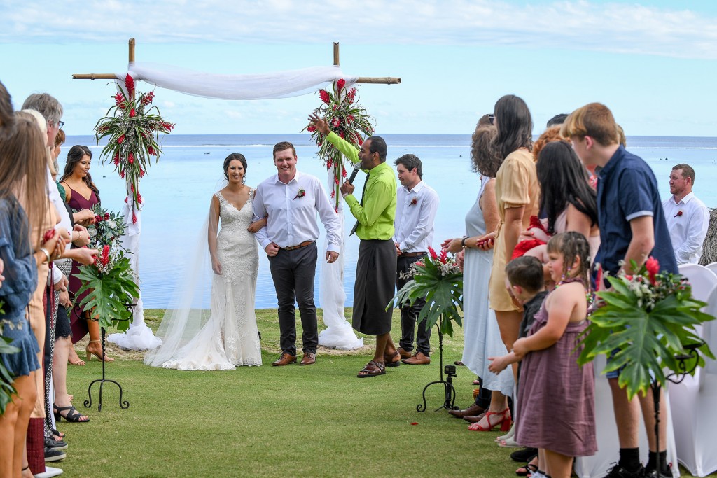 Guests celebrate the newly weds as they walk down the aisle
