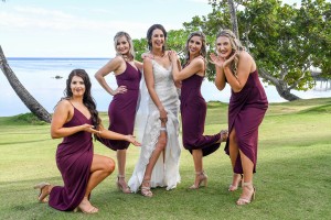 The bride happily poses with her bridesmaids
