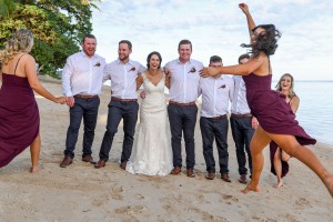 A bridesmaid photobombs the bride's and groomsmen's photo