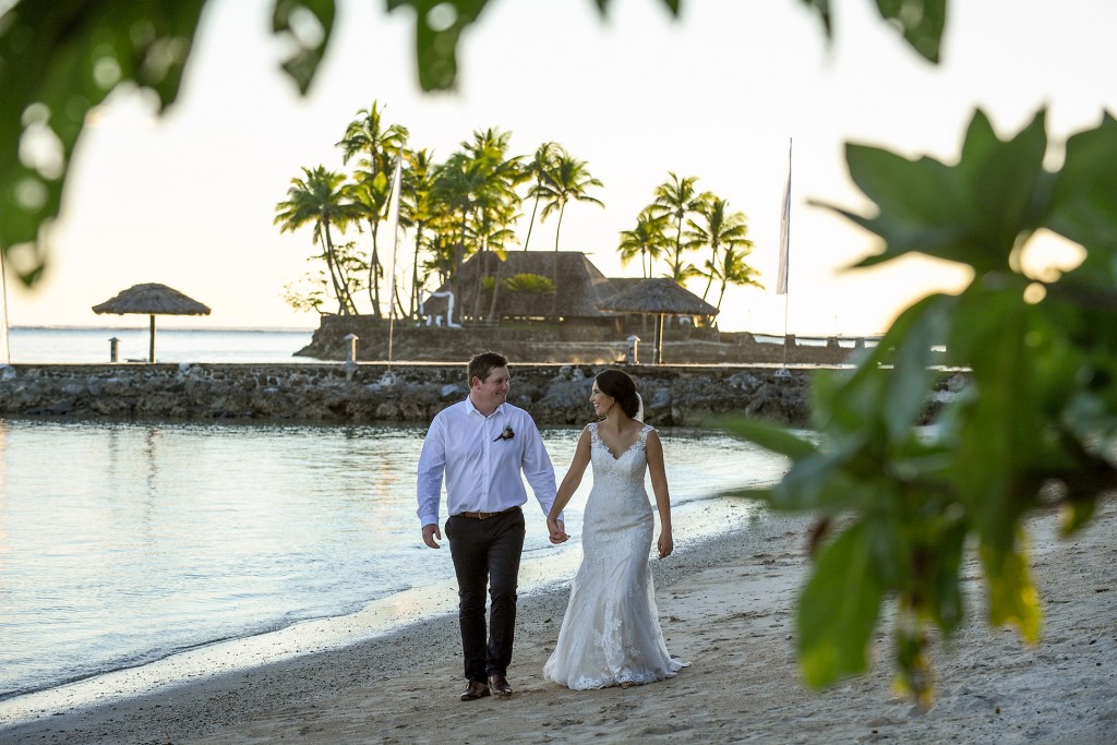The newly weds stroll on the beach at Warwick Fiji
