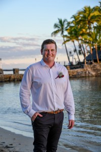 A portrait of the dapper groom posing at the edge of the beach at Warwick Fiji