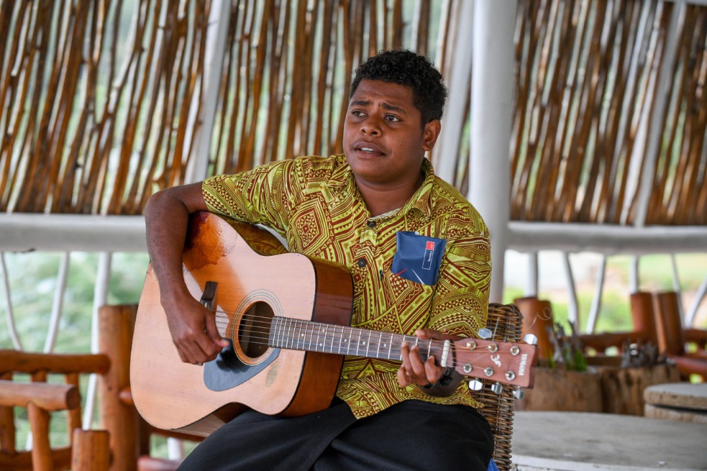 A Fiji serenader strums on his guitar during the wedding ceremony