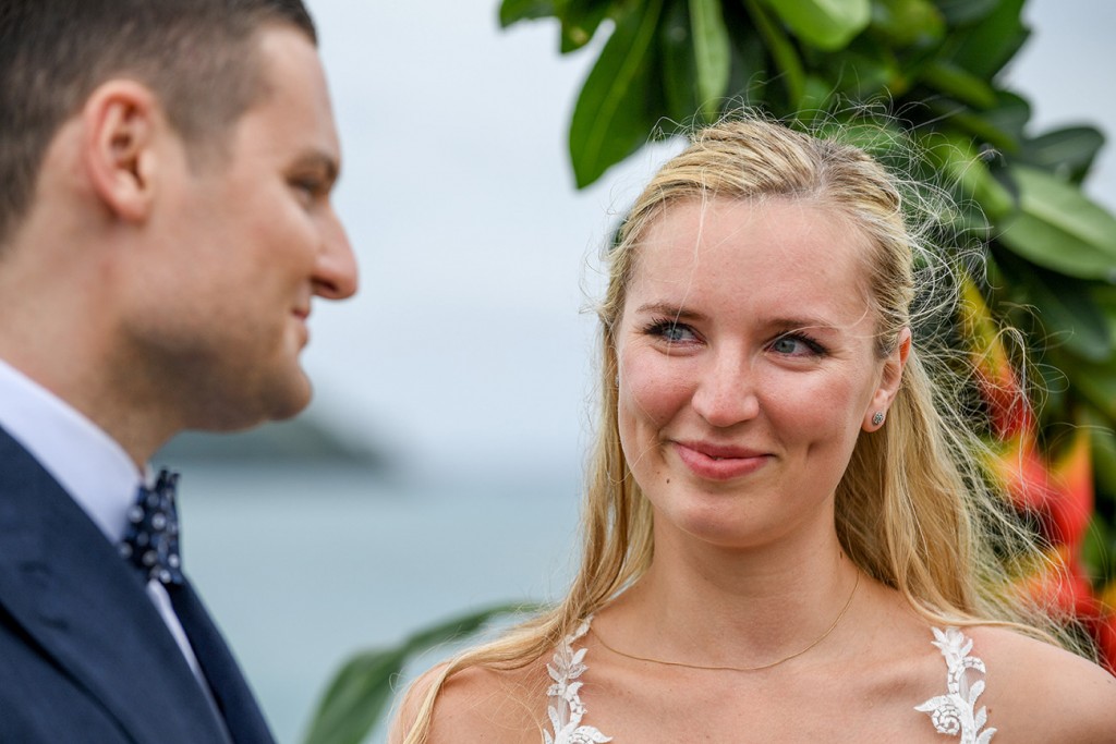 A tearful bride smiles at her groom