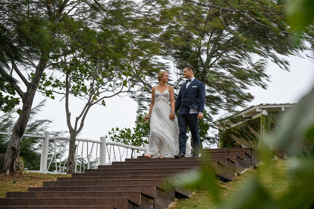 The newly weds hold hands as they walk down steps