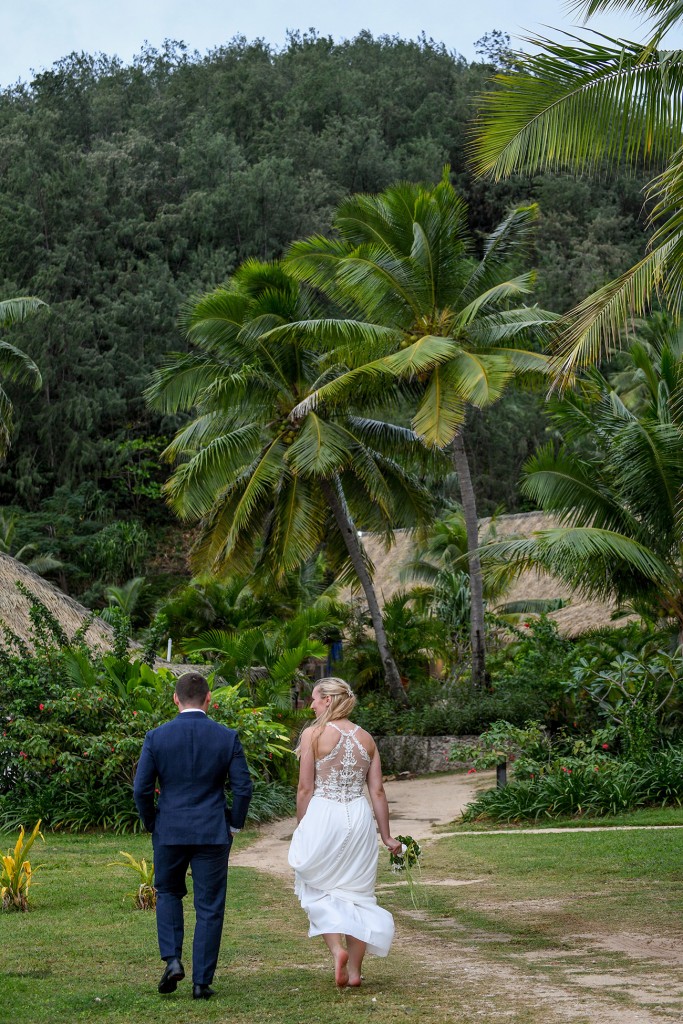 The newly weds walk into the tropical Fiji rainforest
