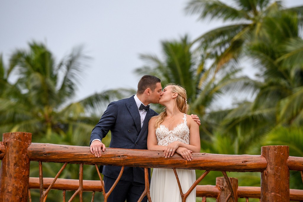 The newlyweds kiss on the pier at Tropica Island Resort