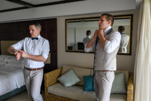 The groomsmen fasten their bow ties as they prepare for the wedding