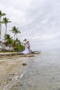 The bride and groom share an intimate moment on the shores of Shangri La Fiji