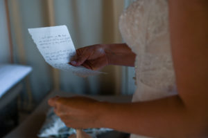 The bride reads a note from the groom before the wedding