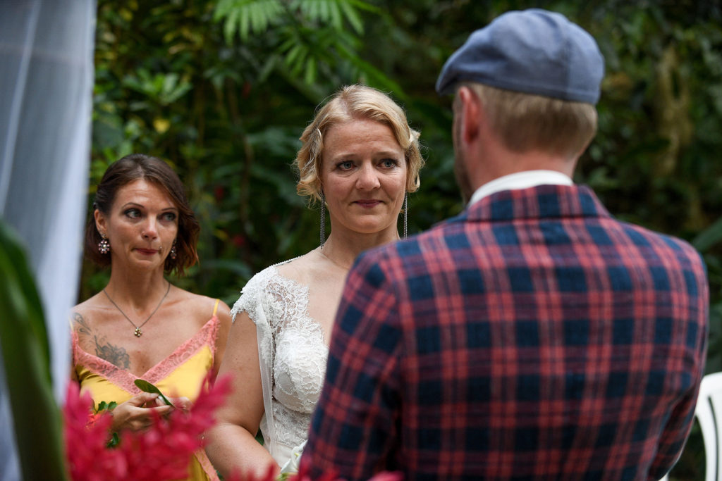 The bride watches teary-eyed as the groom reads his vows