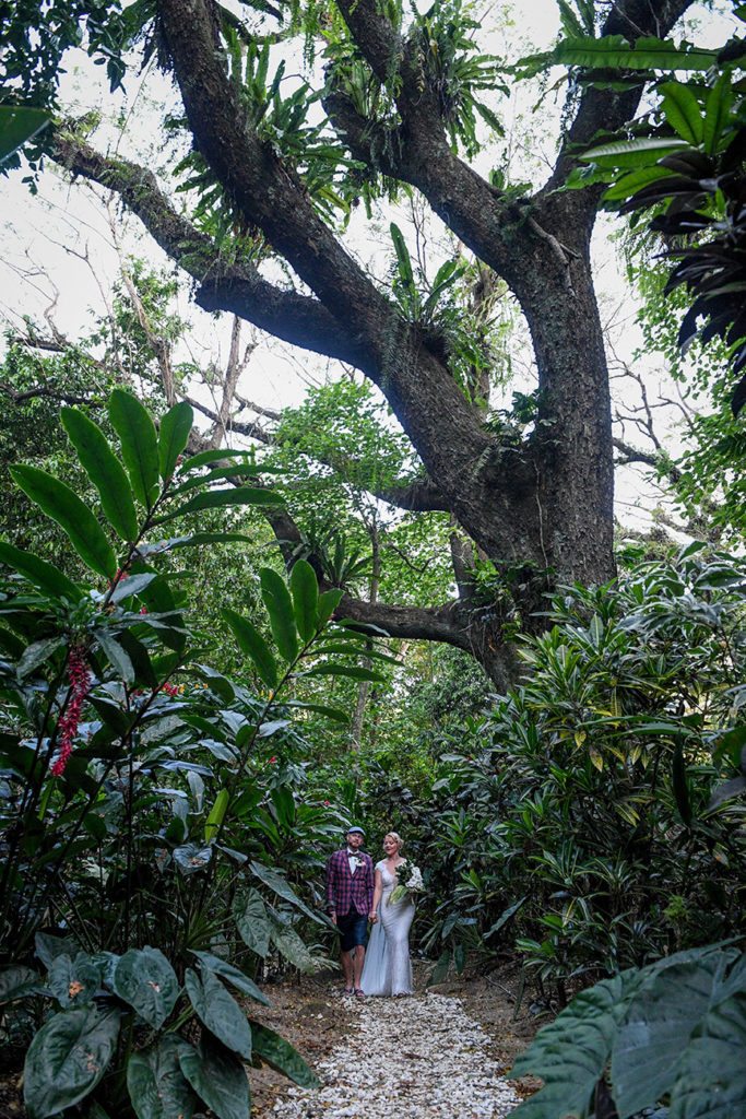 The married couple pose under the towering tropical forests at Savusavu Fiji