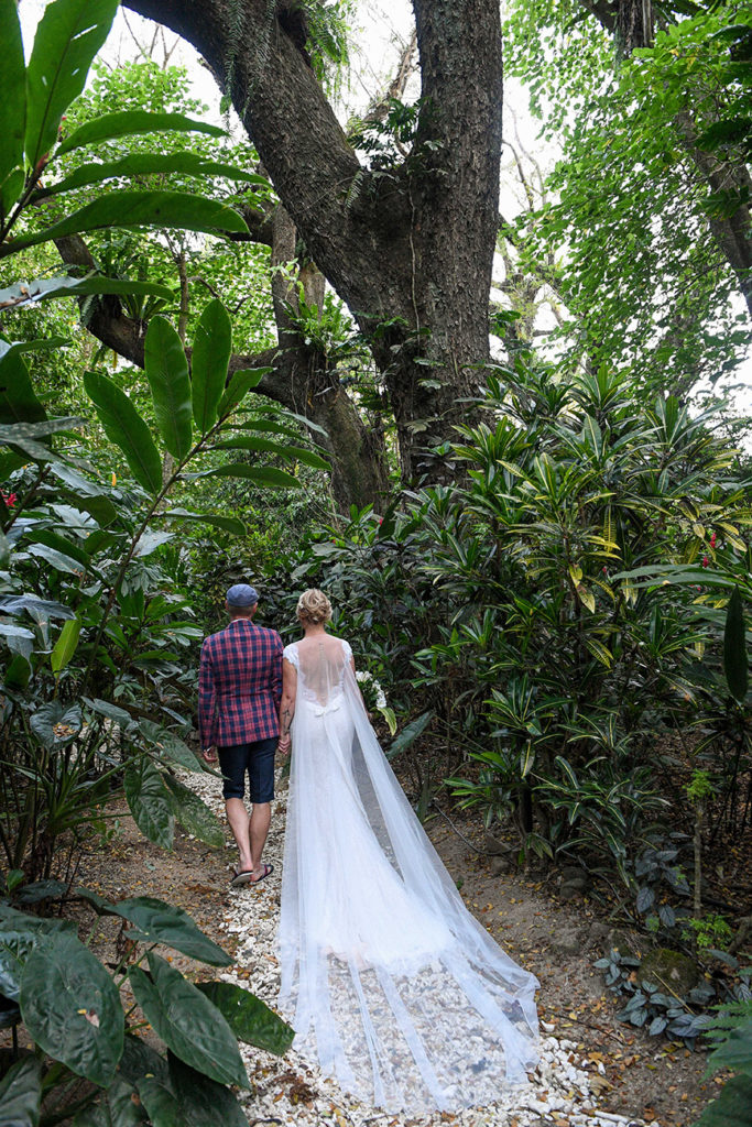 The newly weds stroll under the tropical Savusavu forest in Fiji