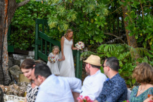 Guests watch as the bride and flowergirl make their way down the aisle