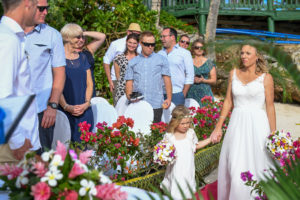 Guests watch as the bride and flowergirl make their way down the aisle
