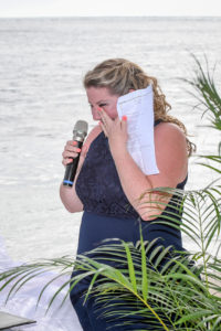 The celebrant wipes a sneaky tear as she officiates the wedding ceremony
