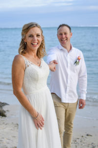The bride leads her groom while on the Shangri La beach